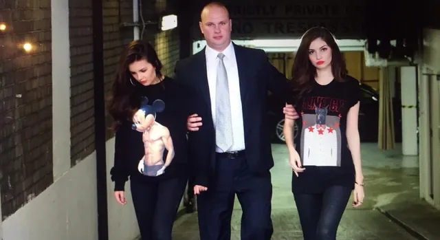 Close protection officer escorting two clients