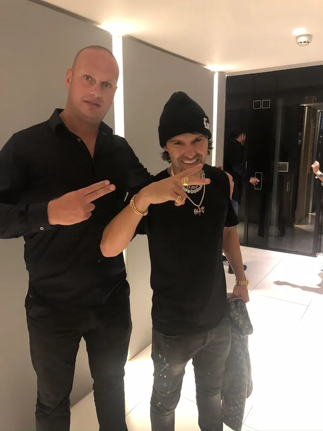 Close protection officer with a client indoors