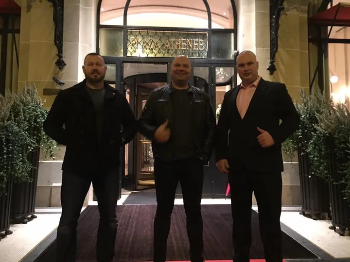 Three door supervisors at a hotel entrance