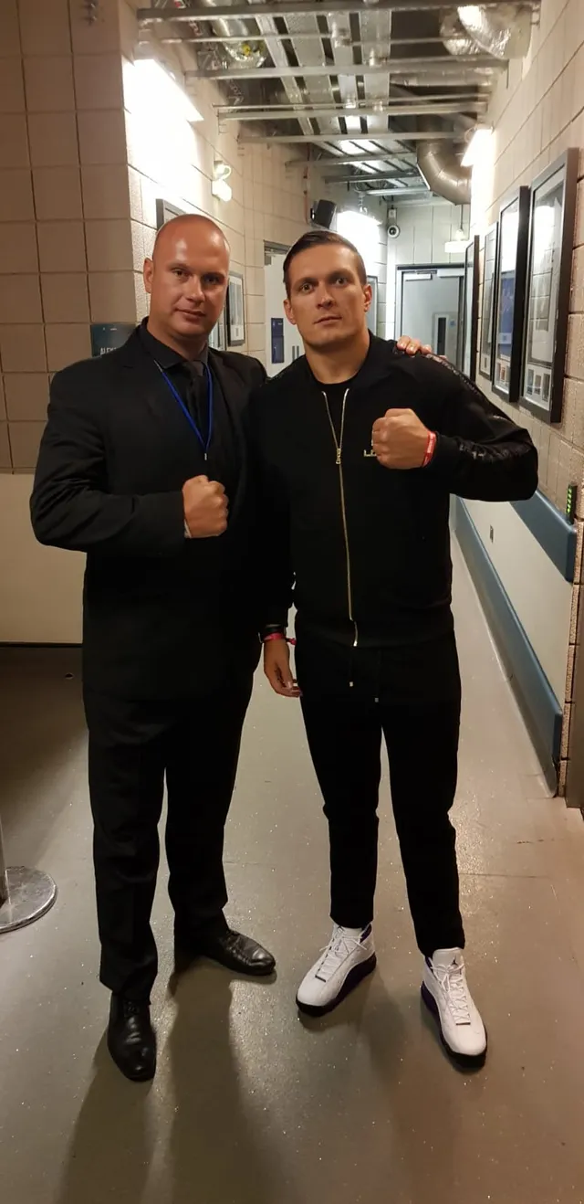 Event security officer with a boxer in an arena corridor