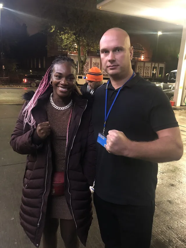 Event security officer with a guest outside a venue at night