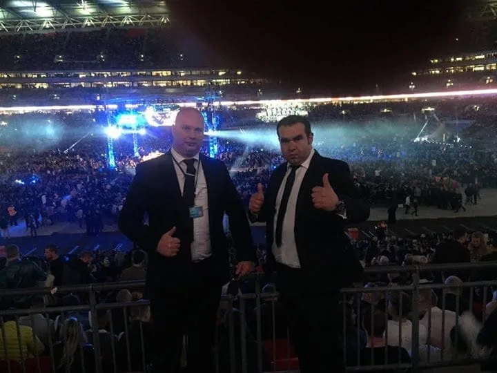 Two security officers at a crowded concert arena