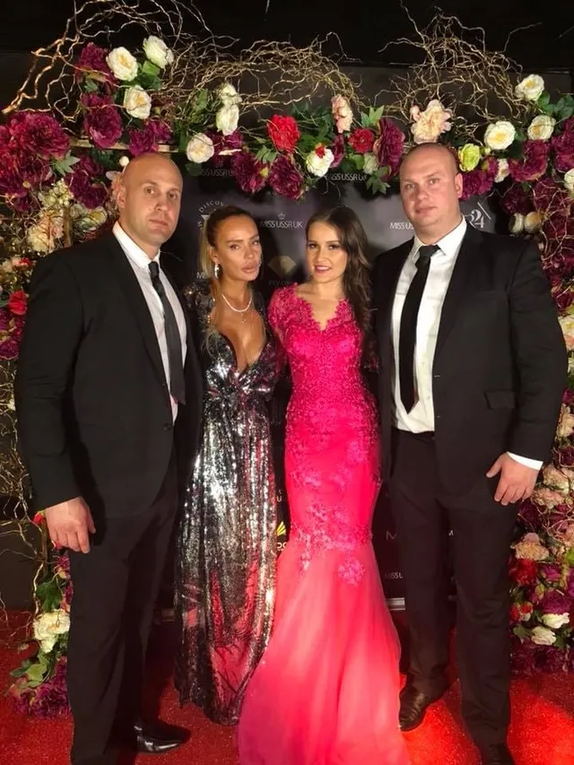 Two event security officers with guests on a red carpet