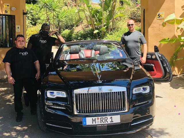 Three executive protection team members beside a luxury vehicle