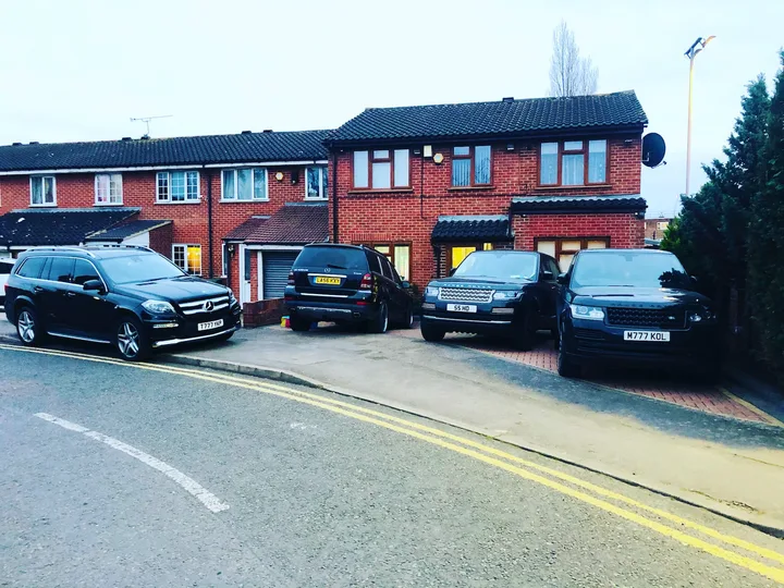 Terraced homes and vehicles on a residential street