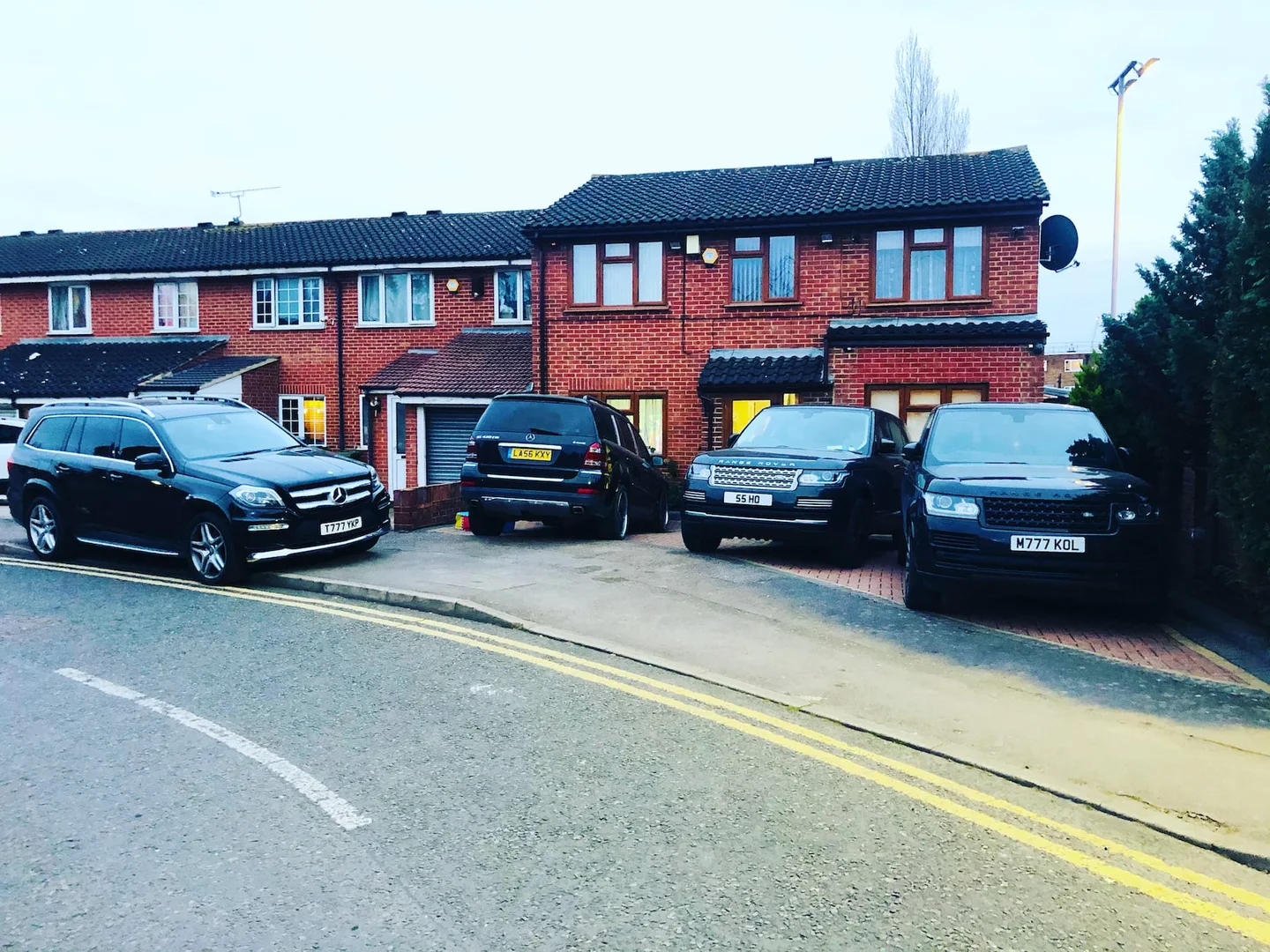 Terraced homes and parked vehicles on a residential street