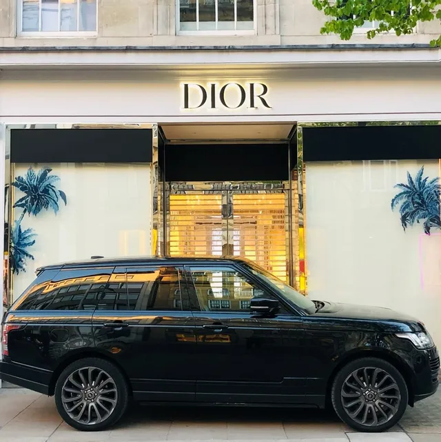 Black security vehicle outside a luxury retail store
