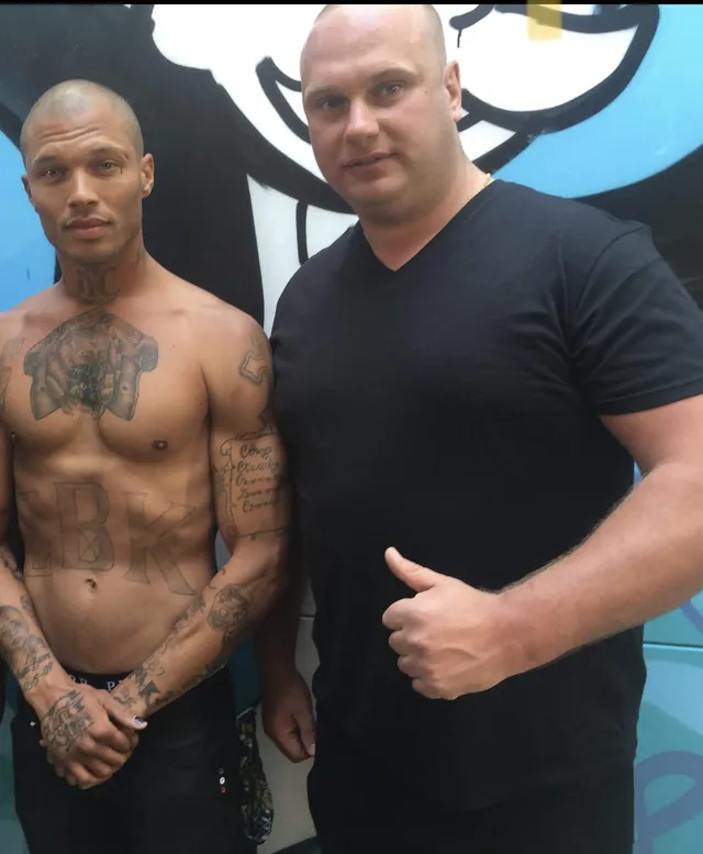 Security professional with a client in front of a mural