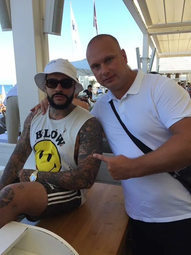 Spetsnaz Security team member with a guest at a beach club